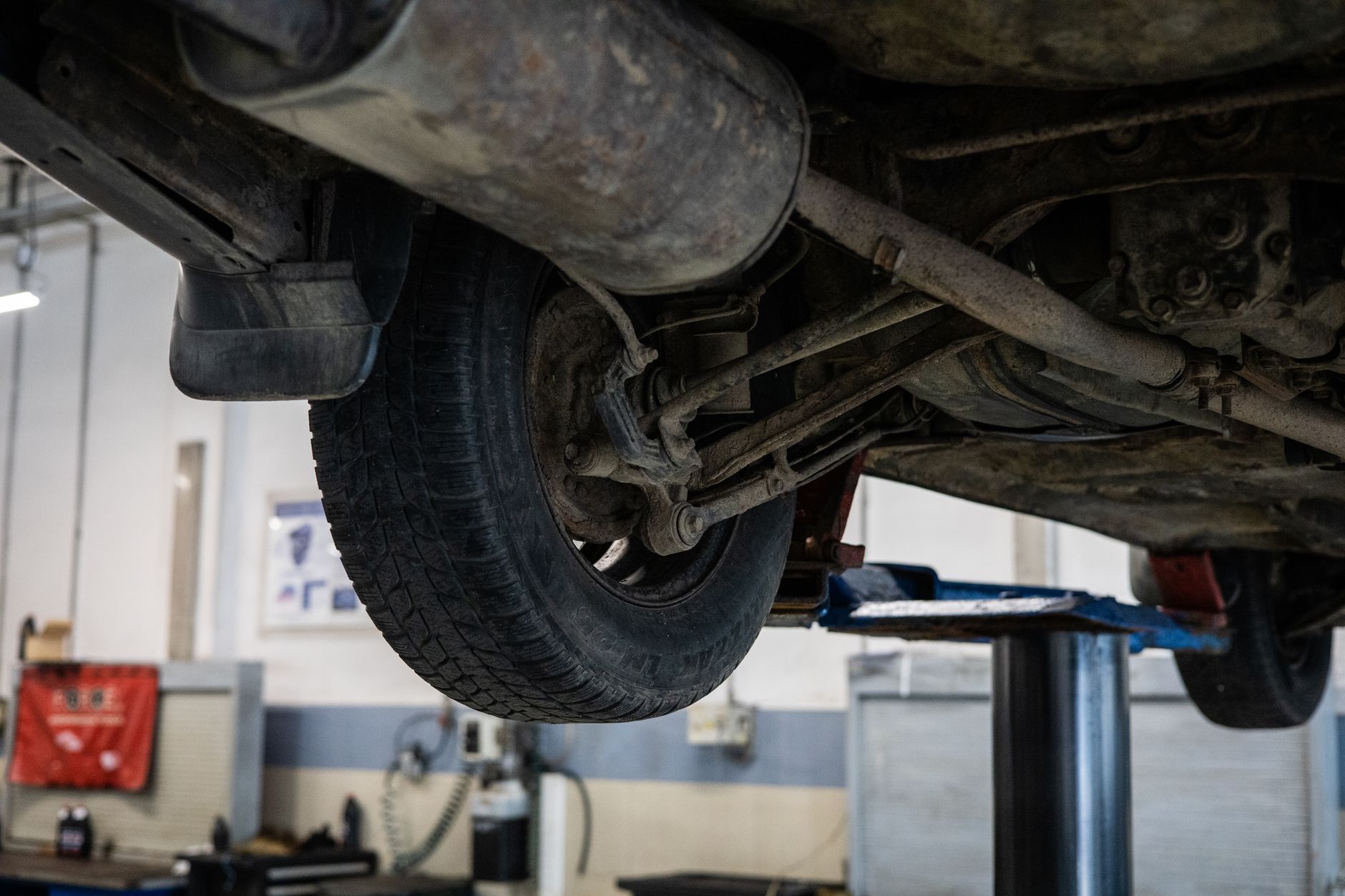 Car on a wheel alignment rack in a garage