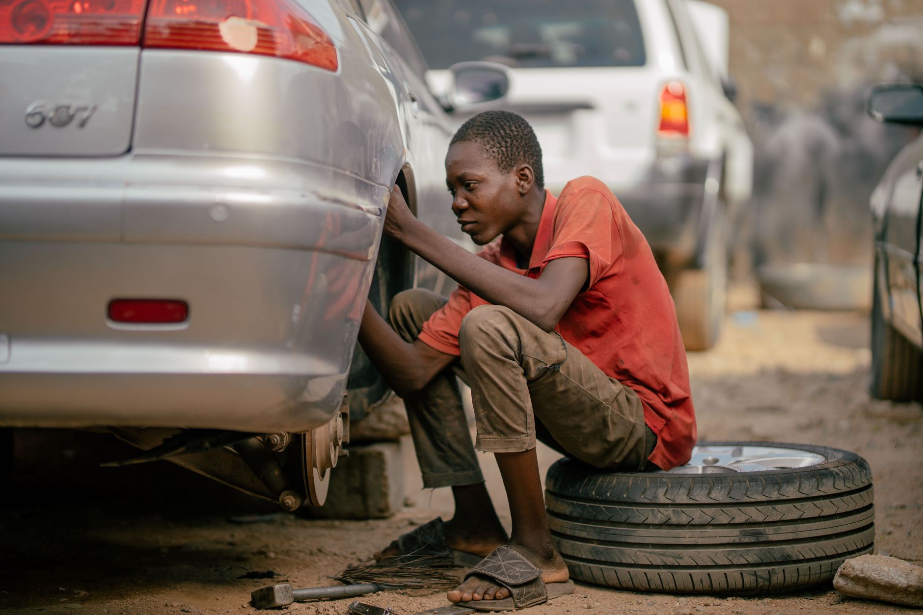 Mechanic rotating a car tire in the shop